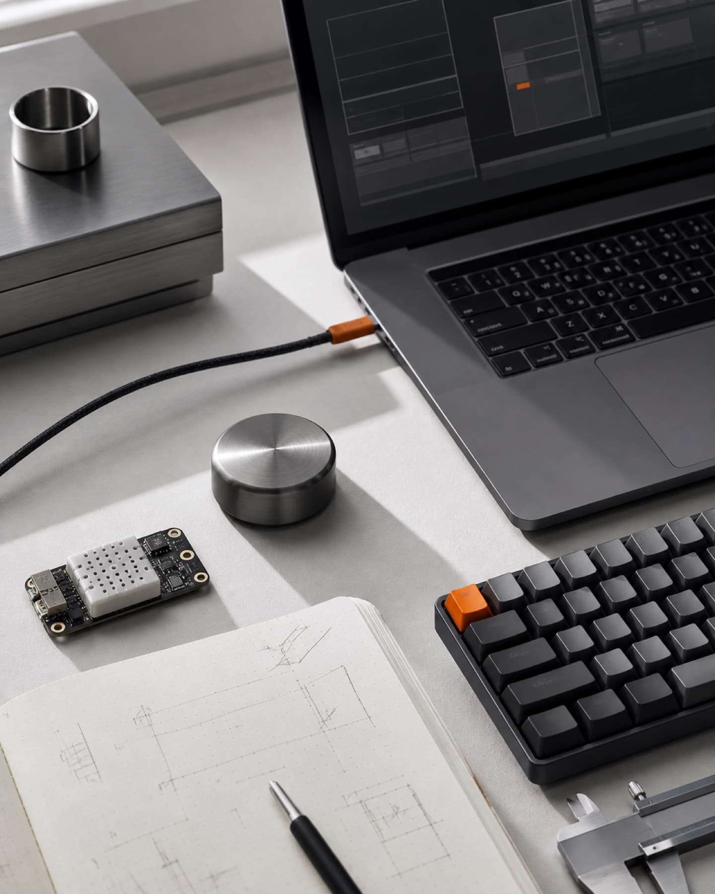 Developer workspace with engineering tools and a technical notebook